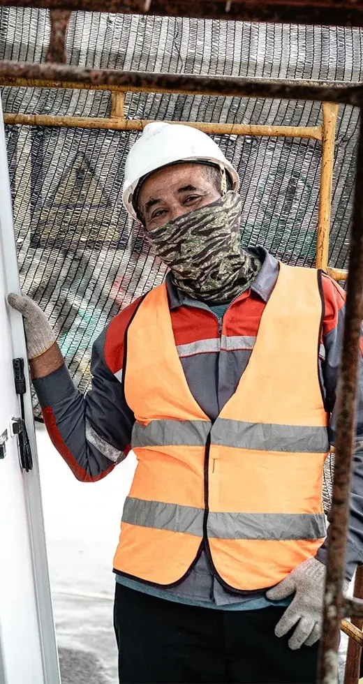 Technician in a safety vest receiving a solar module